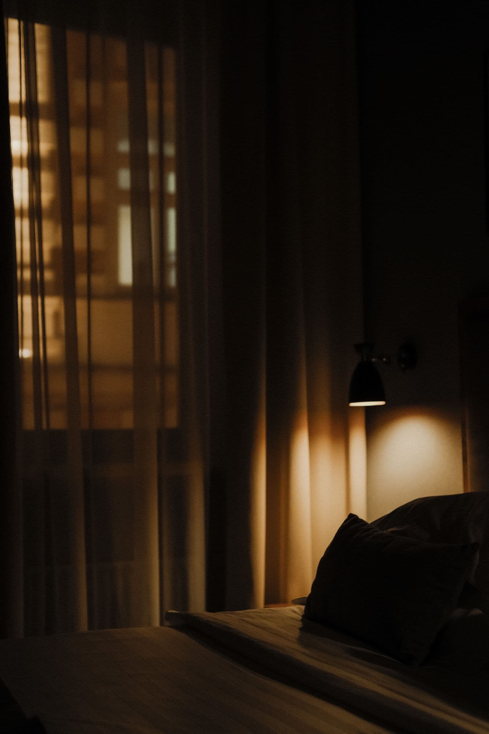 Motorised sheer shades softening the light in a bedroom