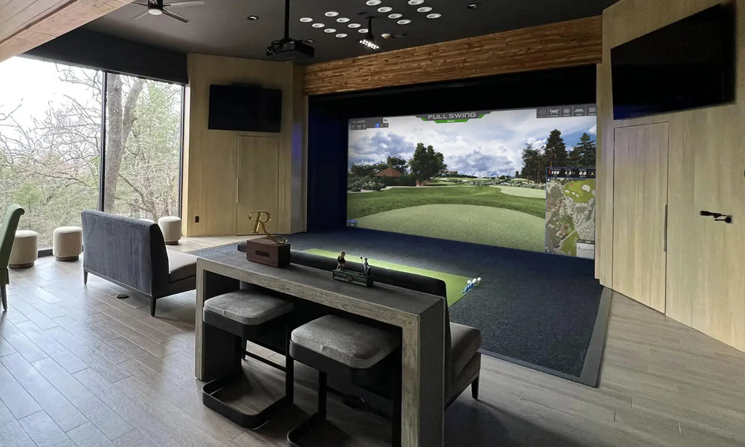 A luxury home golf simulator room, the course lit on the screen