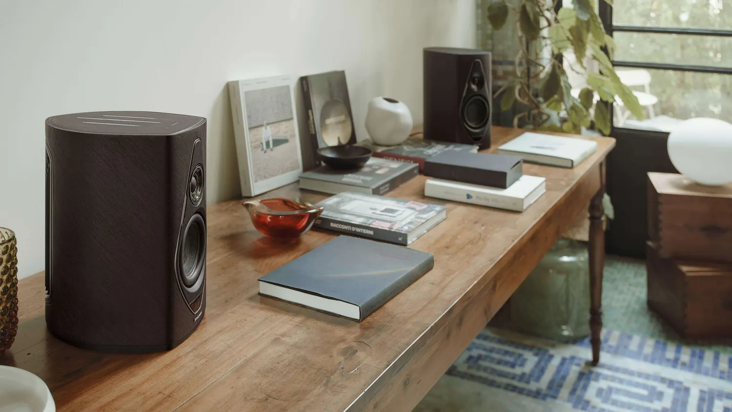 Loudspeakers in a warm, art-filled living room set up for listening