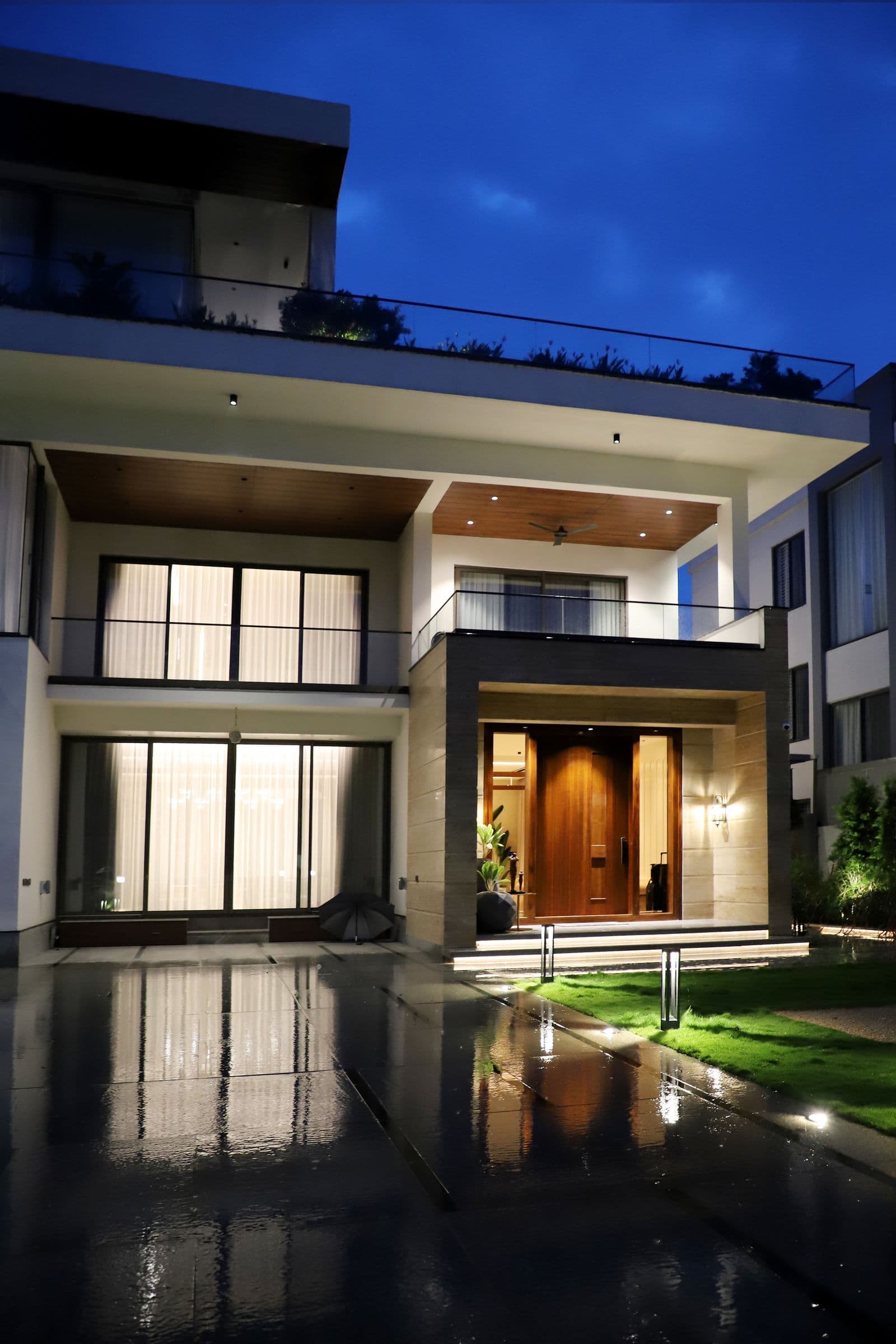A luxury home exterior lit at dusk