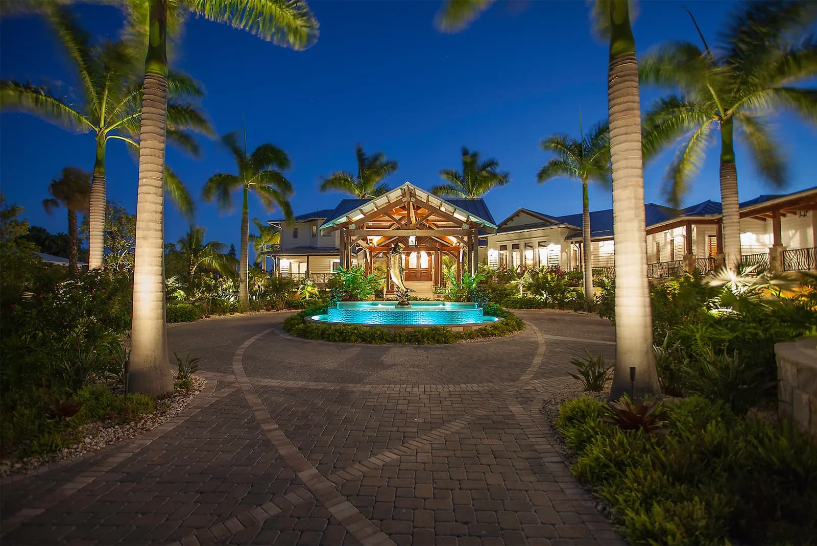 A driveway and garden at dusk, lit in layers with Coastal Source fixtures