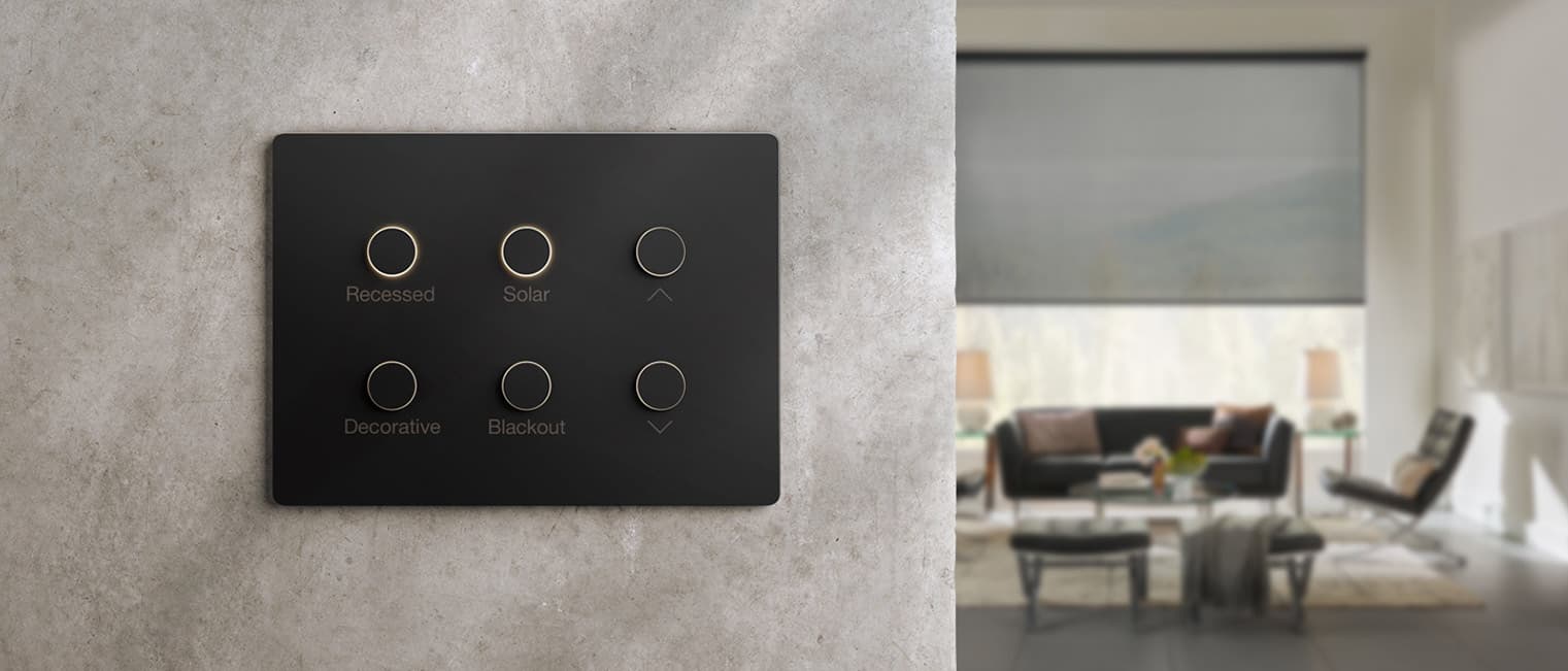 A hand-finished Lutron keypad with gold engraved buttons on a plaster wall
