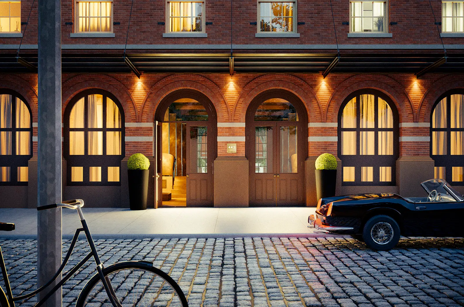 The landmark arched-brick facade of 443 Greenwich at dusk