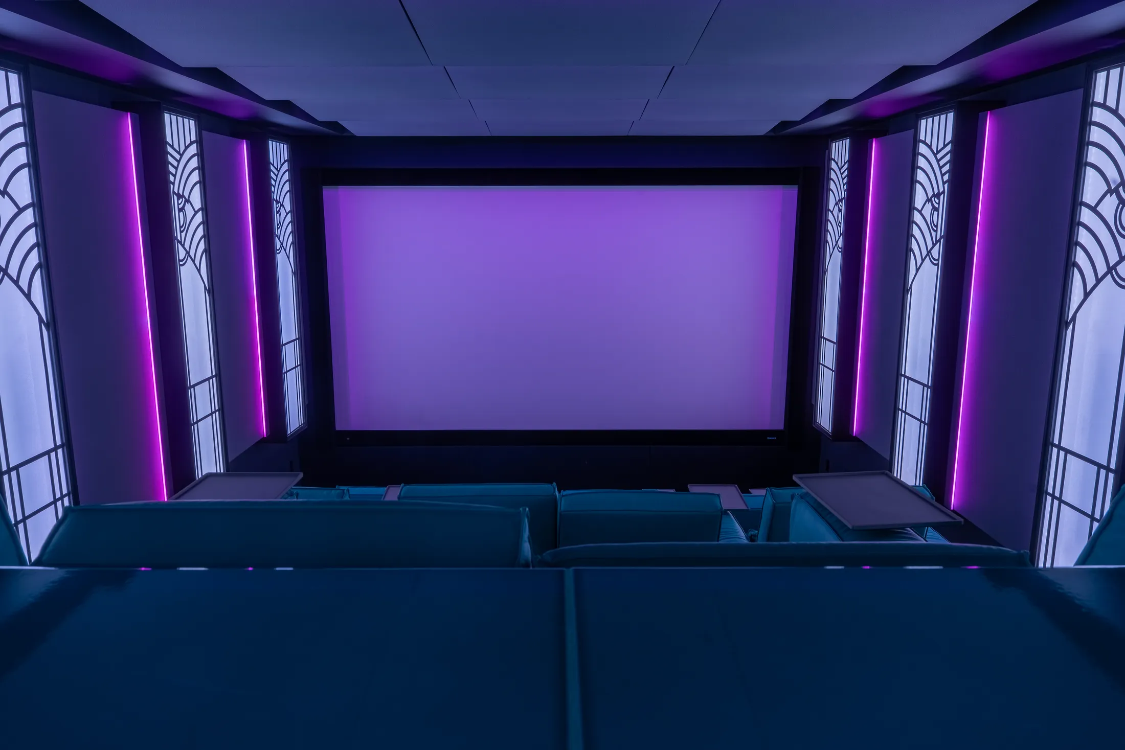 The cinema in blue light, screen lit, Cineak leather seating