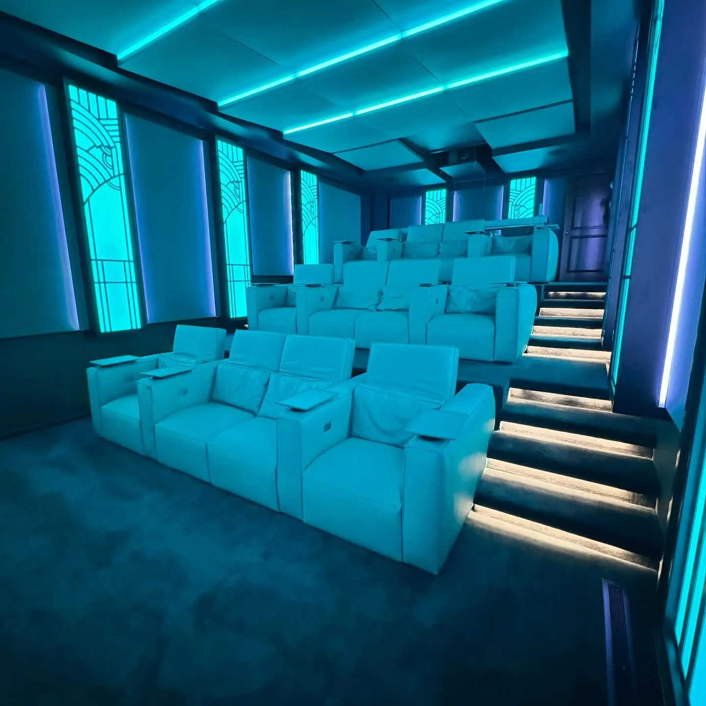 The cinema washed in cyan light, Cineak seating and Art Deco panels