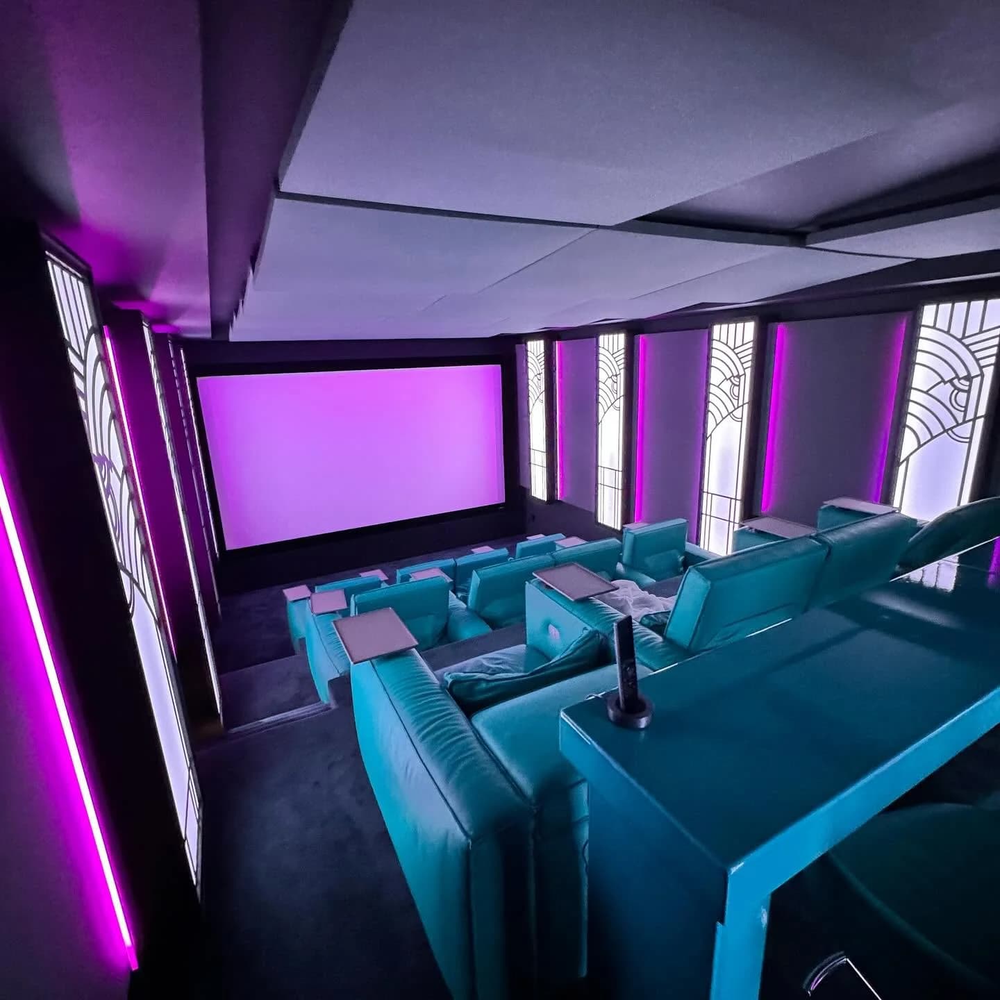 The cinema from above, the room and screen in magenta light