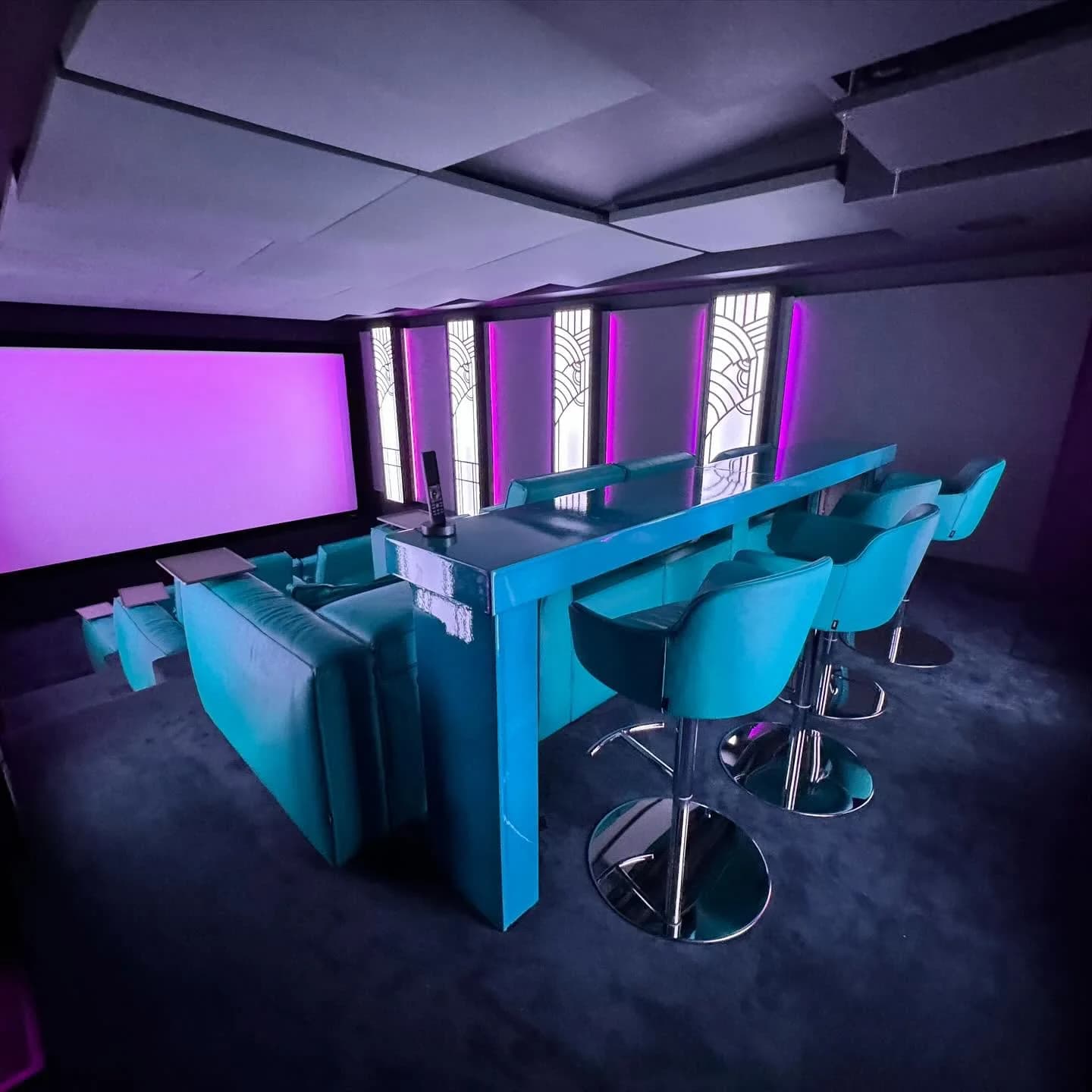The cinema in magenta, the bar rail along the back row