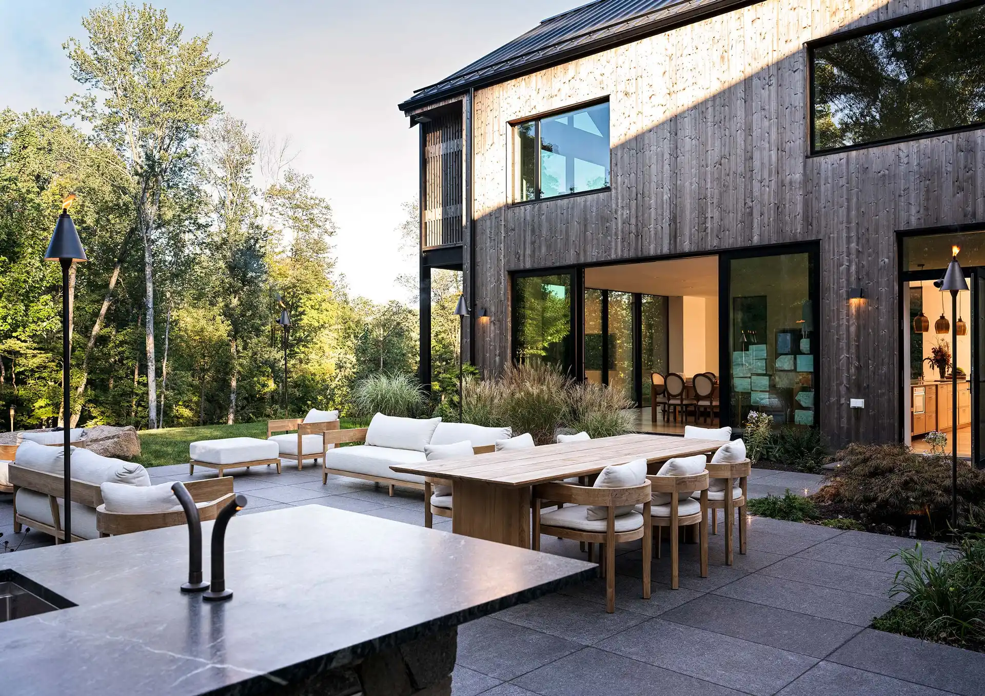 Carbon Home Zero at dusk, the terrace set for entertaining
