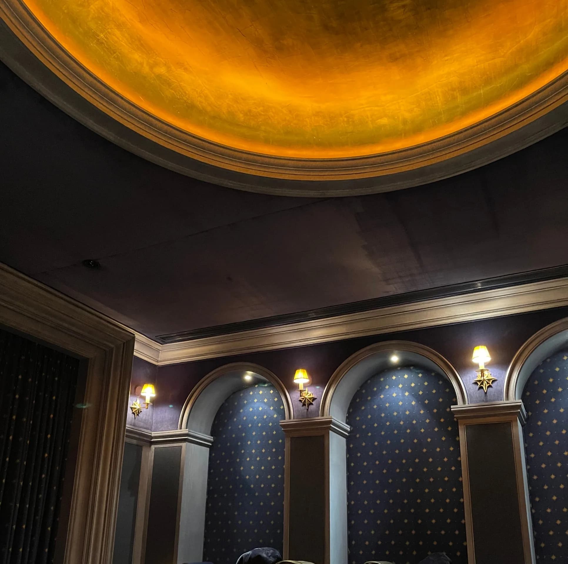 The gold-leaf dome above starred arches and brass sconces