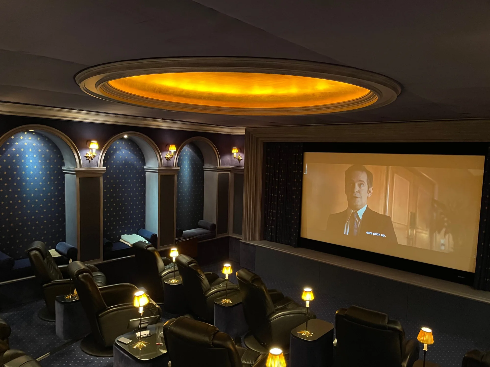 The screen in use, the room lit low beneath the gold-leaf dome