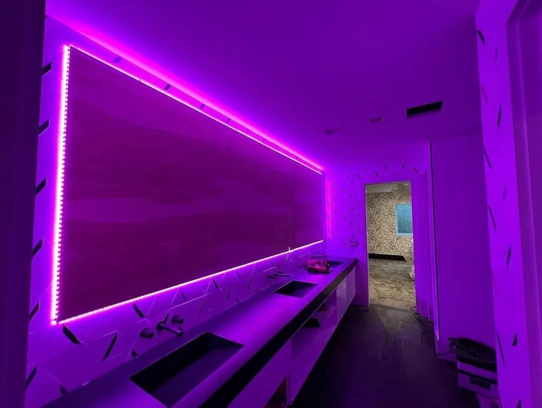 A backlit feature wall washed in magenta