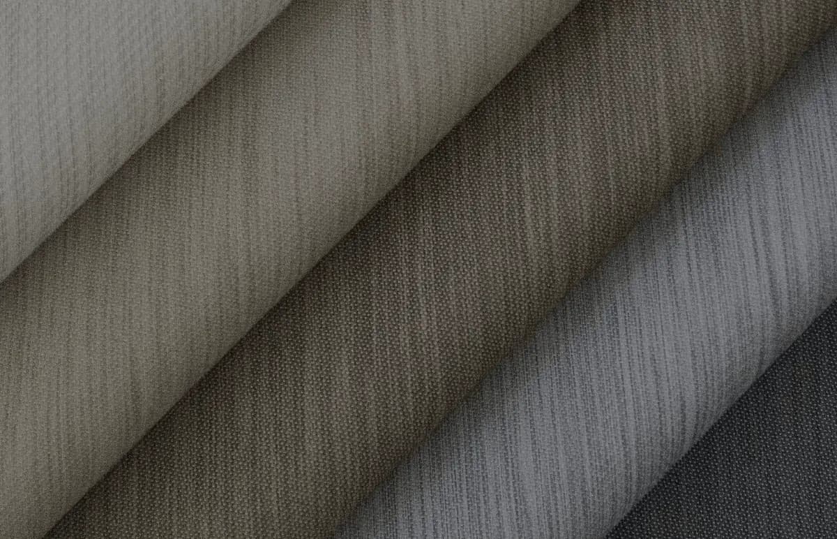 Folded Savant shade textiles in warm neutral tones, from sheer to room-darkening