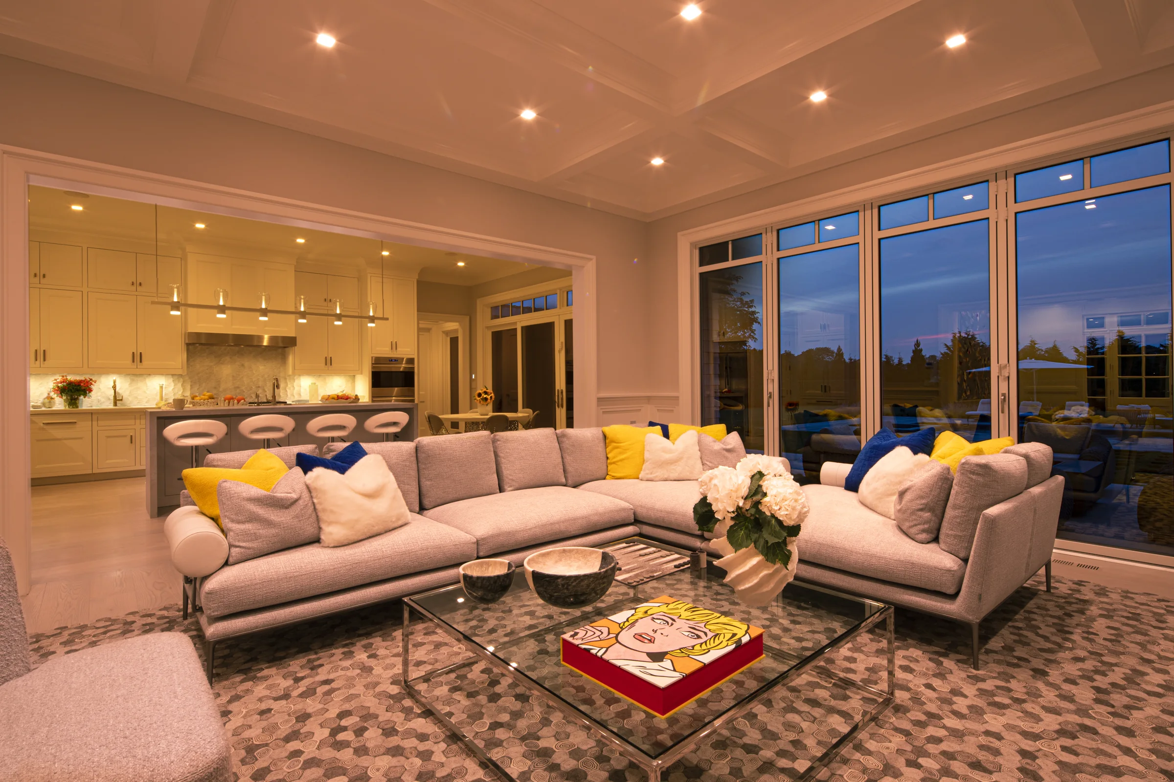 A Savant-lit great room at dusk, warm and calibrated by hand